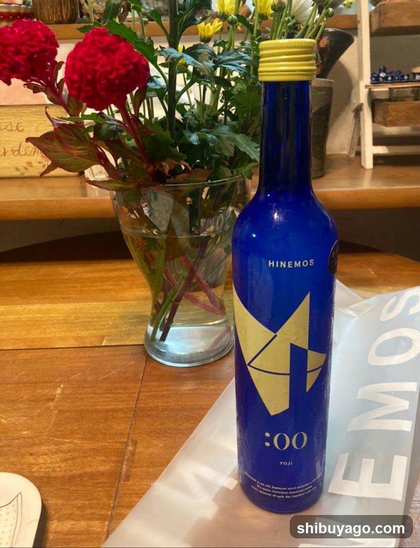 Blue Bottle and Flowers on Table