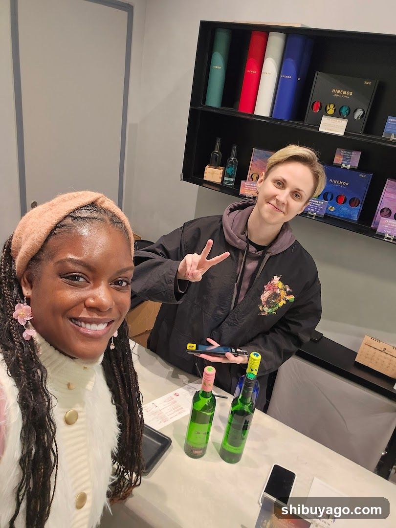 Two people at a counter with wine bottles