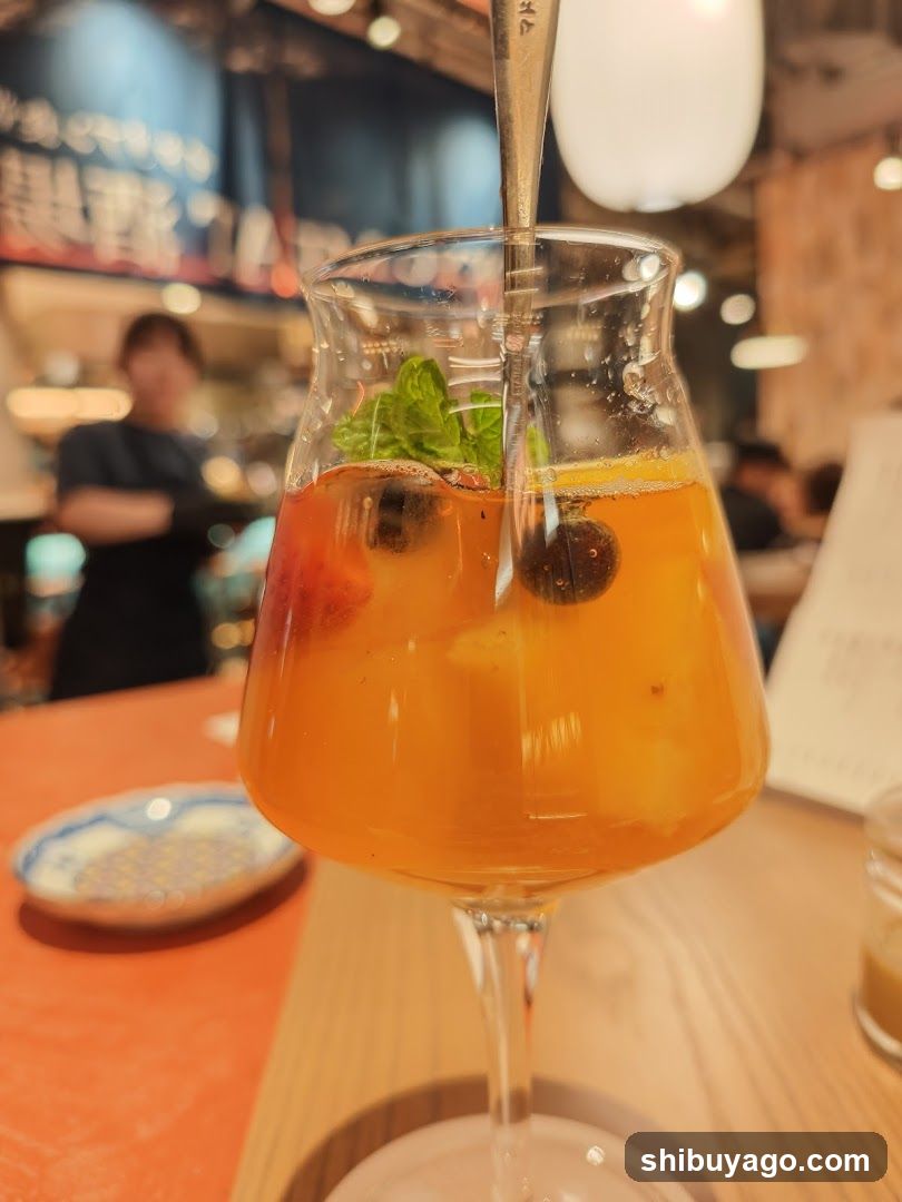 Orange Cocktail with Mint and Berries