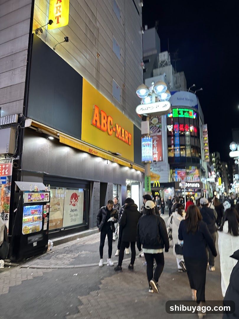 Night street scene with ABC-Mart and crowds