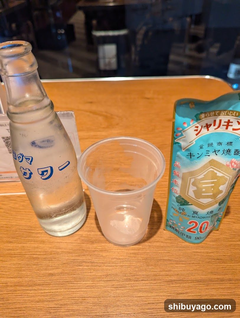 Bottled water and condiment packet on table