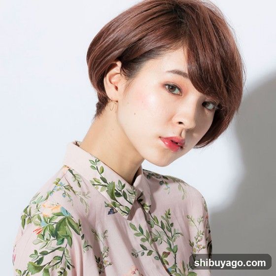 Portrait of a woman with short brown hair wearing a floral shirt