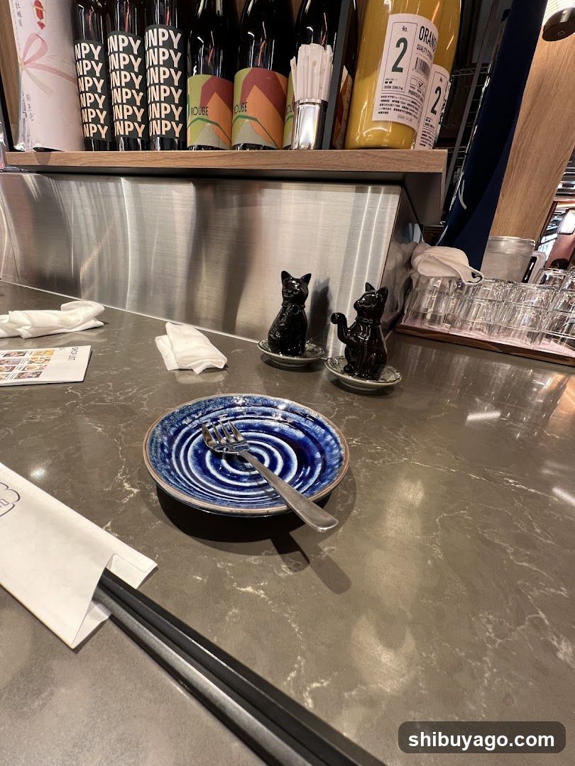 Bar Counter with Decorative Cat Figurines and Blue Plate