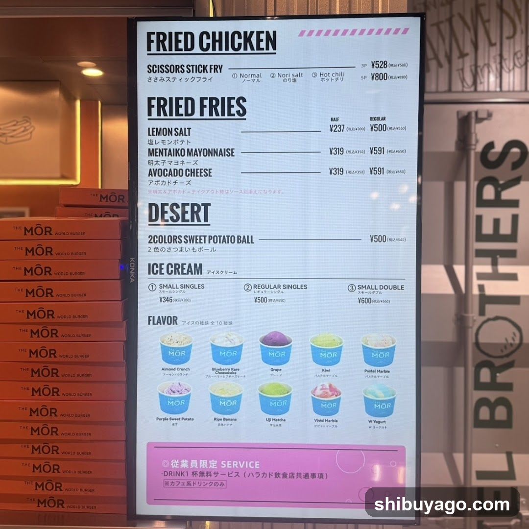 A digital menu board displaying fried chicken, fries, desert items (sweet potato balls), and ice cream flavors with prices in JPY.