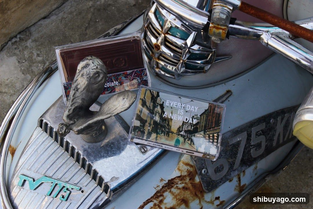 Vintage scooter with cassette tapes and figurine