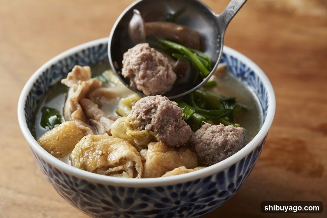 Bowl of Soup with Meatballs and Greens