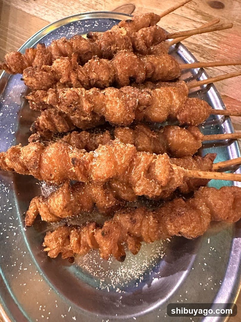 Fried Skewers on Metal Plate