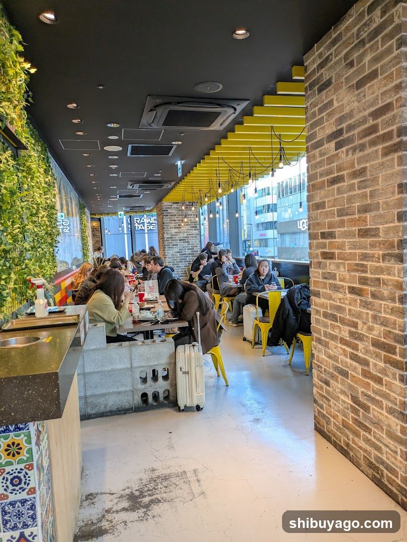 Interior of a casual dining space with brick walls and yellow accents