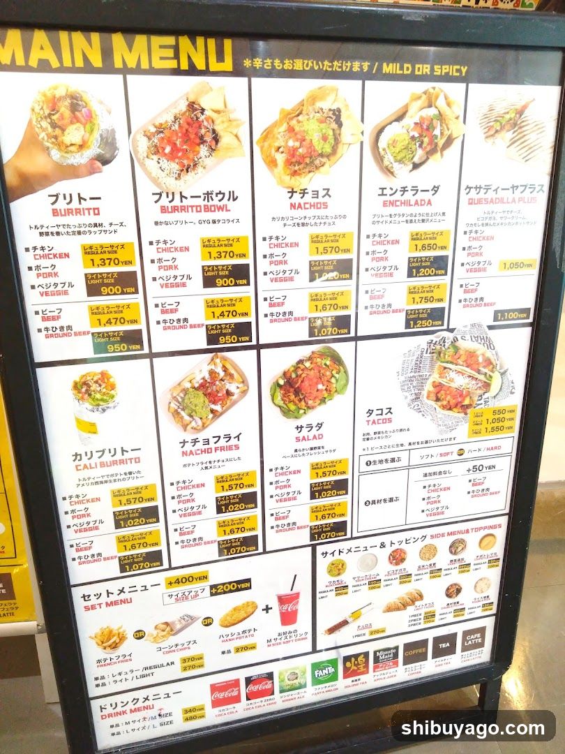 A large menu board displaying various food items with prices in yen, including burritos, bowls, tacos, salads, and drinks.