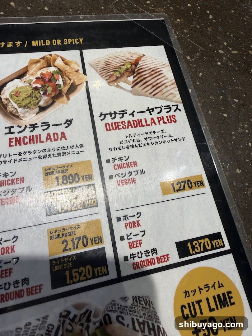 A close-up of a printed menu featuring Japanese and English text, showcasing food items with prices in yen.